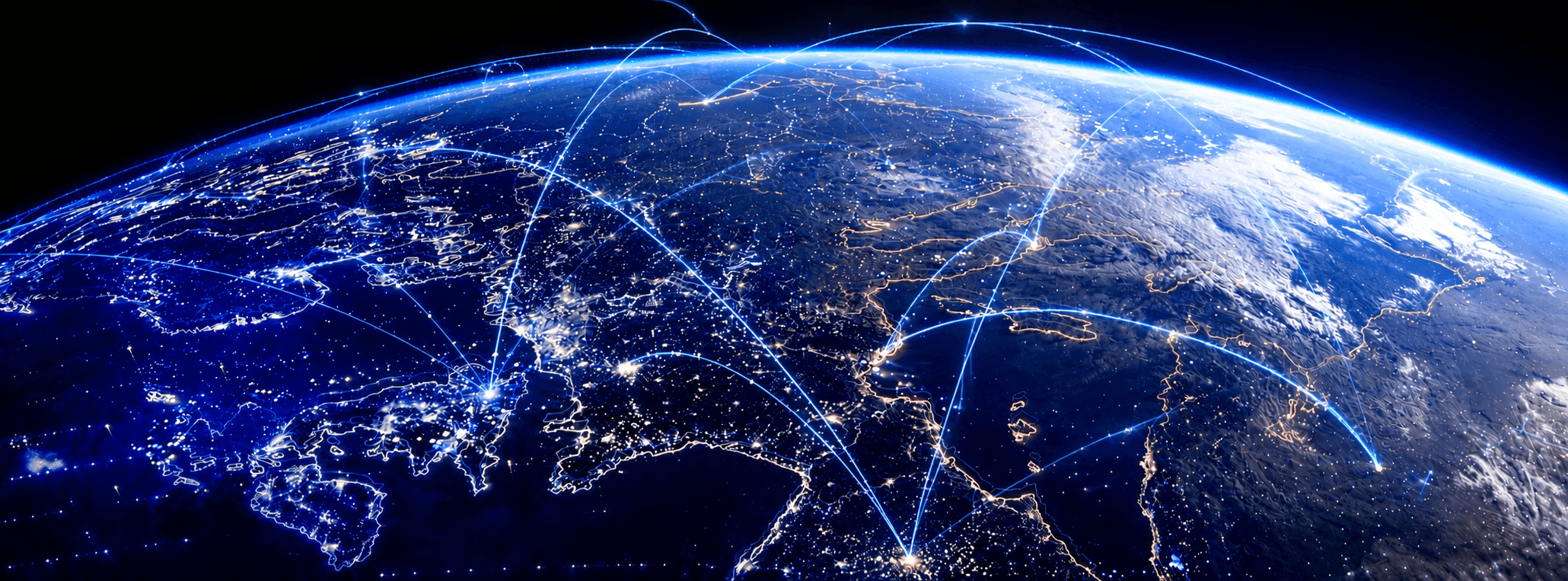 Earth at night seen from space, criss-crossed by glowing arcs representing a global fleet-connectivity network